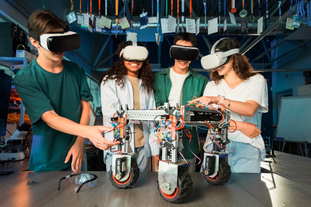 group young people vr glasses doing experiments robotics laboratory robot table 1 - „Wspieramy każdego w odkrywaniu i rozwijaniu swojego potencjału, by żyć pełnią życia”