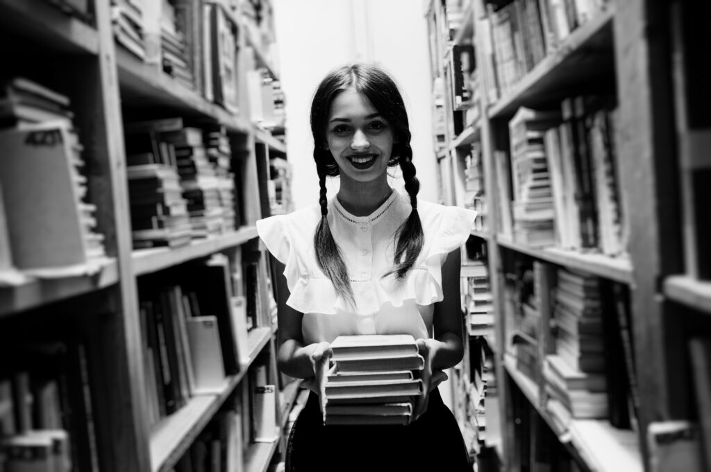 girl with pigtails white blouse old library - „Wspieramy każdego w odkrywaniu i rozwijaniu swojego potencjału, by żyć pełnią życia”